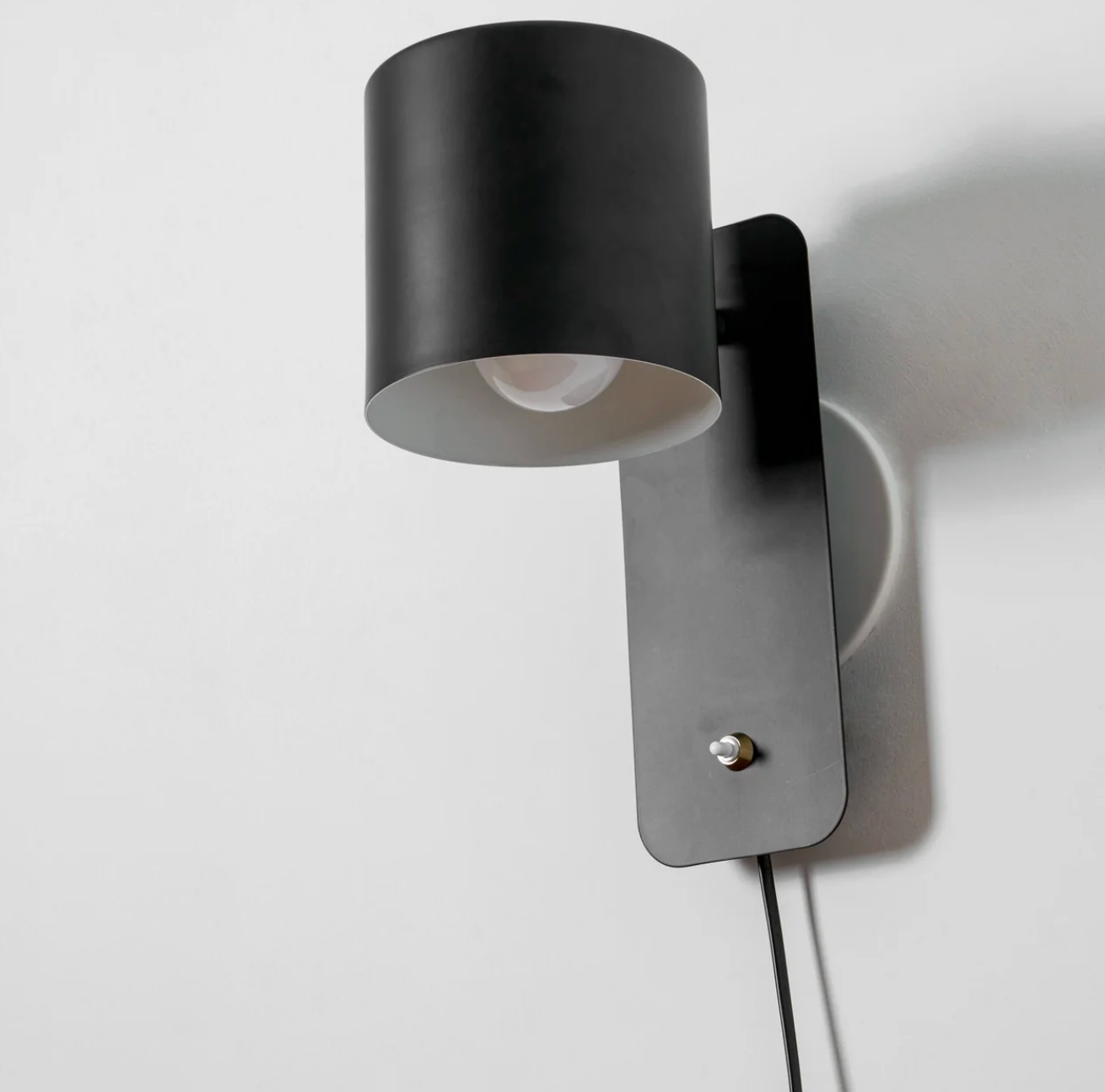 Minimalistyczna kinkietowa lampa ścienna z regulowanym kloszem